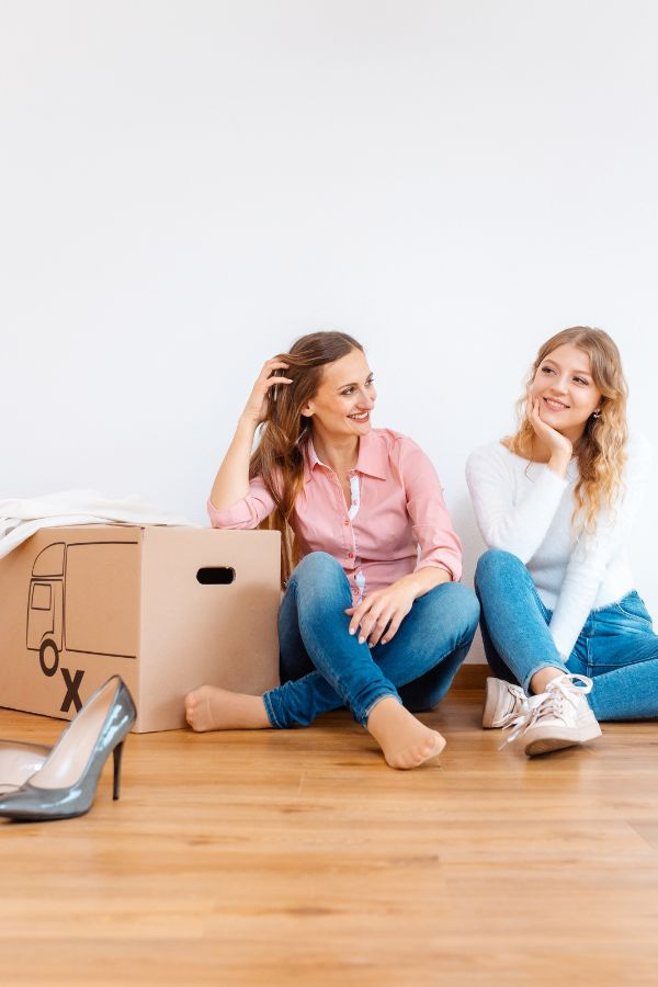 Image of two women unpacking items into a new home